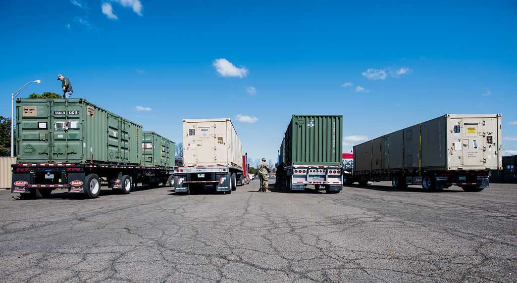 View of the rear of trucks carrying intermodal containers