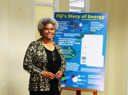 Lenora Salusalu Qereqeretabua, Deputy Speaker of the Parliament of Fiji, poses in front of the LAGI 2025 Fiji energy information graphic at the opening of the exhibition at Fiji Arts Council in Suva.
