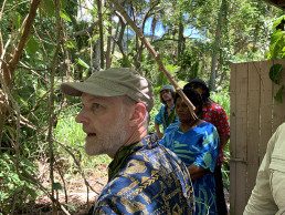 Robert Ferry, Alberto Roncelli, Young Kang, and Lai Kolinivalu walk through the vegetation near the LAGI 2025 Fiji site boundary.