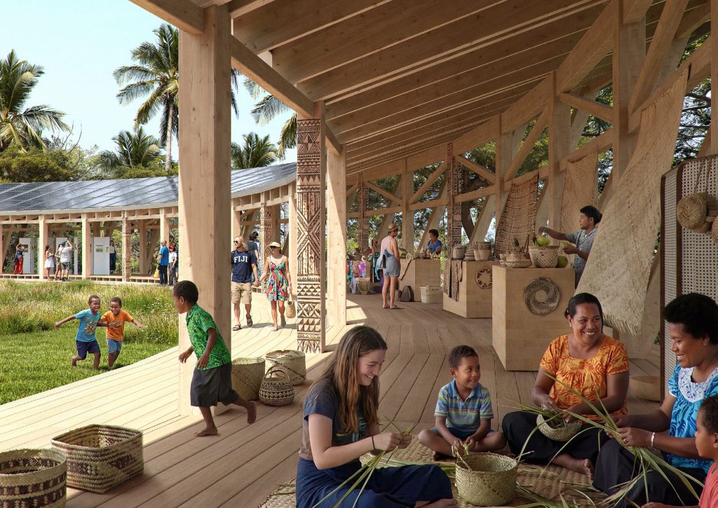 Local residents demonstrate craft skills to visitors in an open pavilion that curves around to the distance on the left side. Children play and there is an exhibition in the background.