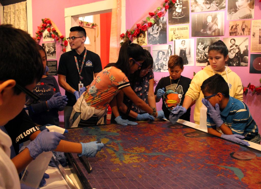 The film is applied as a community project to the Solar Mural artwork, En Aquellos Tiempos Fotohistorias del Westside. Photo by Penelope Boyer.