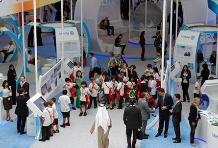 School children explore the LAGI 2010 exhibition, part of the Masdar booth at the 2011 World future Energy Summit. Photo taken from the balcony above.