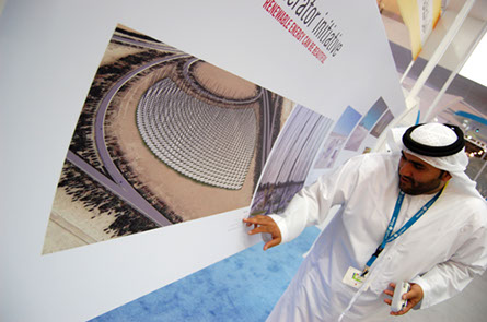 Emirati gentleman points to the image of WindNest, part of the LAGI 2010 exhibition.